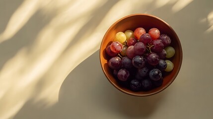 Poster - A top-down view of a small bowl of grapes and blueberries, carefully placed on a clean table, plain background, 4K resolution