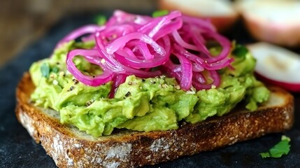 Close-up of avocado toast topped with pickled red onions.