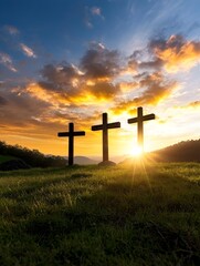 Dramatic sunset scene with three crosses standing tall and silhouetted against the vibrant golden rays of the fading light  The serene peaceful landscape creates a contemplative spiritual atmosphere