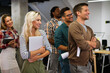 © NDABCREATIVITY - Group of young multi-ethnic startup business team collaborating on project in modern office