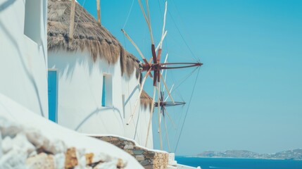 Wall Mural - A serene view of the picturesque countryside and traditional windmills of Mykonos with clear blue skies and rustic charm, island setting with bright whites and ocean blues, Mykonos style