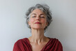 © Oksana_Latysheva - Portrait of a beautiful happy retired mature woman closing eyes and breathing deeply isolated on white background