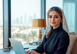 © Aleksej - Elegant Arab Businesswoman Working in a Modern Office Overlooking the City Skyline with a Laptop
