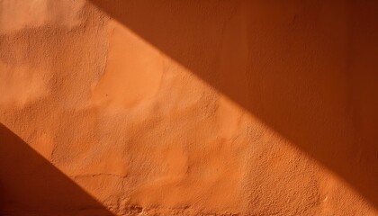 Poster - Warm Textured Orange Stucco Wall with Strong Diagonal Sunlight Shadow. Ideal for Rustic and Minimalist Backgrounds, Mood Boards, or Creative Design Concepts Evoking Warmth and Natural Texture