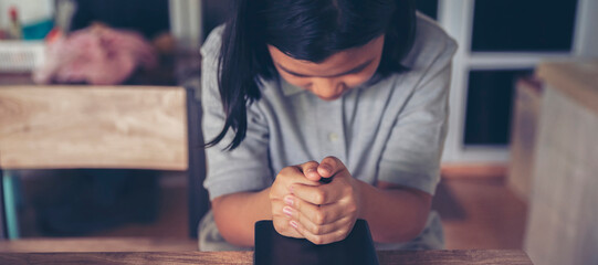 Pray concept. Asian children hope and pray for peace and end to War, Hand in hand together by kid, believe and faith in christian religion at church-banner image.