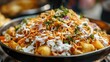 © P.G - A close-up of aloo tikki chaat topped with chutney, yogurt, and crunchy sev, served from an Indian street vendor.