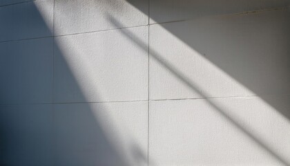 Poster - Minimalist Textured White Wall with Diagonal Sunlight and Shadows. Perfect for Backgrounds, Web Banners, or Modern Design Concepts