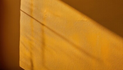 Poster - Warm Golden Wall with Diagonal Sunlight and Shadows, Minimalist Textured Background for Design and Mood Concepts, Highlighting Abstract Play of Light in Photography, Zen and Calm Ambience