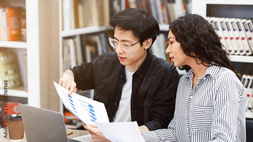 Assignments. Asian guy and mexican girl working and studying in public ...