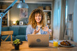 © Miljan Živković - one woman adult caucasian work on her laptop at home happy smile