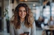 © Pooja - Cheerful young businesswoman holding a smartphone in a meeting room, Generative AI