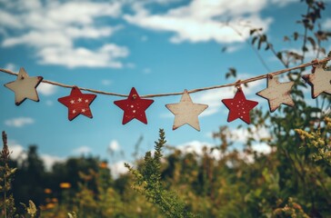 Colorful stars hanging outdoors against a blue sky with clouds on a sunny day