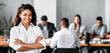 © Prostock-studio - Black Businesswoman Smiling At Camera Posing Standing In Modern Office During Corporate Meeting. Free Space