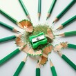 © FREDCassandra - green color pencils sharpener and shavings on abstract light white background close up symbol of drawing creativity education art create concept