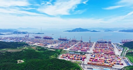Fototapete - Aerial shot of cargo container shipping terminal and mountains and seascape