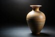 © Phetthanousack - Vase with wide opening narrowing towards bottom isolated on dark background high angle view