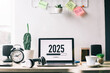 © Gatot - Office desk with 2025 loading bar on laptop screen for happy new year concept