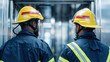 © AlexPhototest - Two firefighters in protective gear stand in elevator, ready to respond to emergency. Their yellow helmets and reflective stripes highlight their preparedness and focus