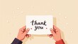 © Irina - Cozy illustration of hands presenting a handwritten 'Thank You' note on a soft background