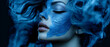 © Daniel - A tight shot of a woman's face, smeared with blue paint Her hair billows in the wind