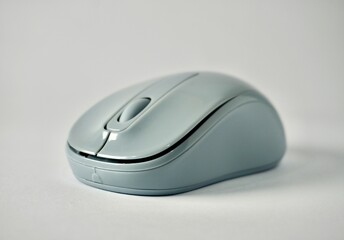 One gray bluetooth wireless mouse with no cable isolated on horizontal ratio plain background.