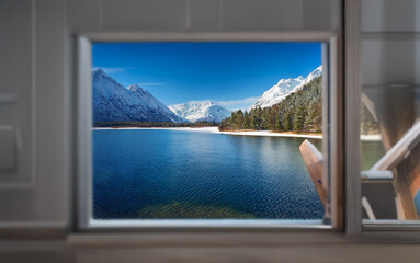 Poster - A small window reveals a breathtaking mountain lake scene, with snow-capped peaks and a serene blue expanse of water.