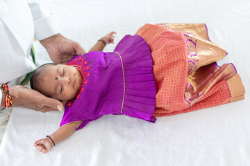 Wall Mural - An Indian family wearing traditional and casual costumes spends time with their baby, girl and grandparents in a high-rise apartment building in Kuala Lumpur, Malaysia. June 2024