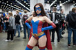 © Axel Bueckert - Cosplayer wearing female superhero costume posing at comic convention