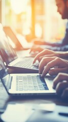 Poster - Individuals engage in collaborative work using laptops in a well-lit office, contributing to projects in systems integration and professional services