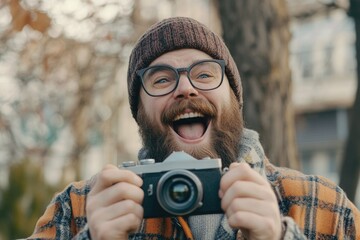 A person with a beard and glasses holding a camera, ideal for use in educational or instructional content