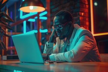 Poster - A person sitting at a desk with a laptop, ideal for office or workspace settings
