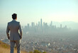 © PTD - man in suit stands overlooking city skyline, embodying ambition and contemplation. hazy atmosphere adds sense of depth to urban landscape