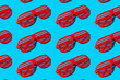© VISTA by Westend61 - Pattern of red striped futuristic fashion glasses over blue background