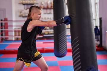 Wall Mural - Kickboxer hitting the heavy bag