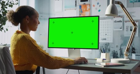 Poster - Black Female Engineer Works at Desktop Computer With Green Chroma key Screen in Modern Office, Focusing on Engineering and Creative Tasks. Innovation and Productivity of Entrepreneur and Designer