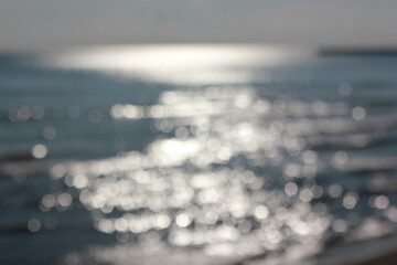 Wall Mural - a blurry dreamy view of waves lapping on the beach.