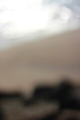 Wall Mural - a blurry dreamy view of waves lapping on the beach.
