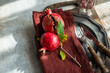 © RooM The Agency - Close-up overhead view of a rustic place setting with fresh ripe pomegranates