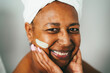 © DisobeyArt - Senior african woman skin mask beauty treatment on her face - Cosmetic and skincare concept - Main focus on nose