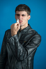 teenage man claiming against censorship isolated on a blue background