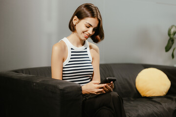 Woman Relaxing on Sofa with Phone