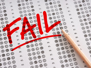 Wall Mural - The word Fail written on a sheet of test exam paper with pencil.