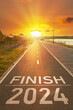 © Вера Тихонова - 2024 year end concept. Motivational inscription for to summary the year. Finish 2024 year is written on empty asphalt path in the bright rays of the sunset. Summing up the year background