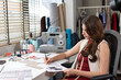 © winnievinzence - Young fashion designer woman drawing sketches pattern clothes. dressmaker working in workshop studio desk. SME small business owner self-employed.