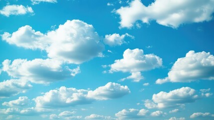 Poster - Soft white clouds scattered across a bright blue sky creating a tranquil and serene backdrop