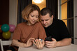© yta - man and woman with smartphone, reading messages, smiling at mobile device