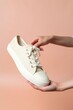 © Rawpixel.com - Canvas shoes footwear white hand.