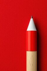 Poster - A close-up view of a red pencil on a vibrant red background, highlighting its texture and color contrast, perfect for art and design visuals.