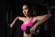© kamonrat - Focused Woman Lifting Dumbbells During Shoulder Workout in Gym, Wearing Pink Sports Bra, Demonstrating Strength, Fitness, and Determination in Weight Training Routine for Upper Body Development