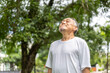 © Art_Photo - Elderly man enjoying fresh air in serene park setting, relaxation outdoors, senior citizen practicing mindfulness and healthy living, peaceful nature moment, breathing exercise in natural environment